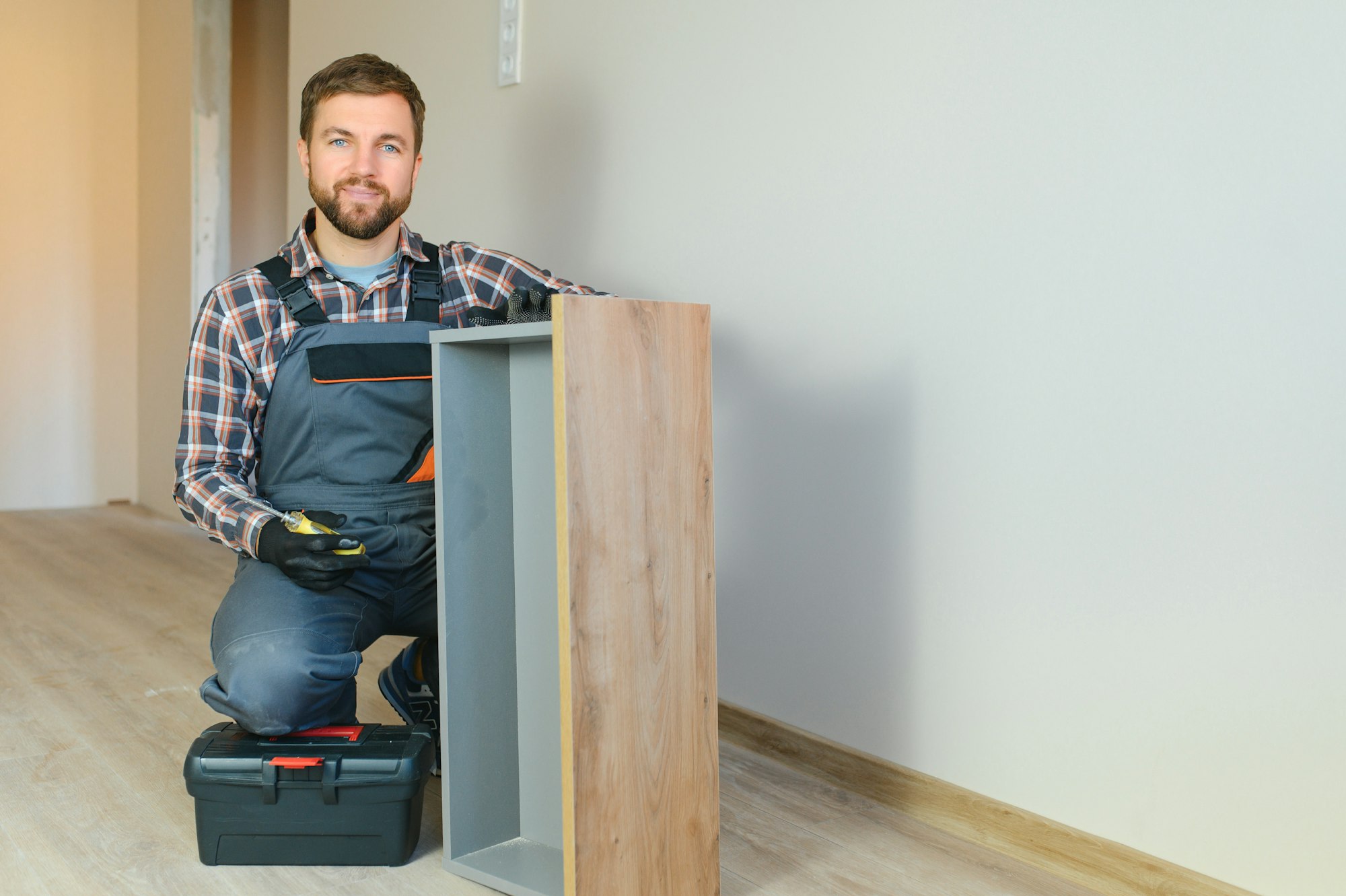 professional furniture assembly worker assembles shelf 